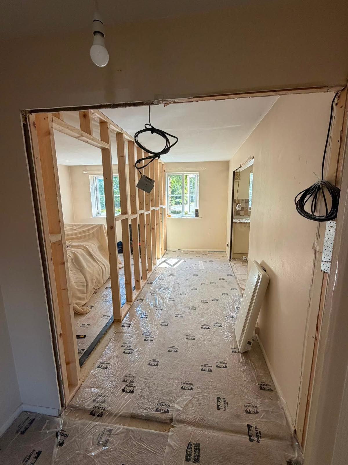 Timber stud partition being formed in a corridor during refurbishment works